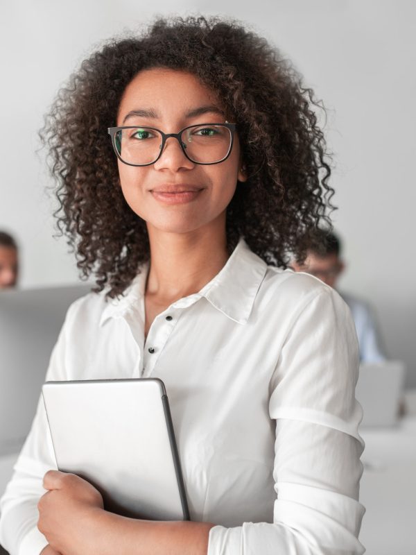 smiling-ethnic-female-recruiter-with-tablet-looking-at-camera-in-office.jpg